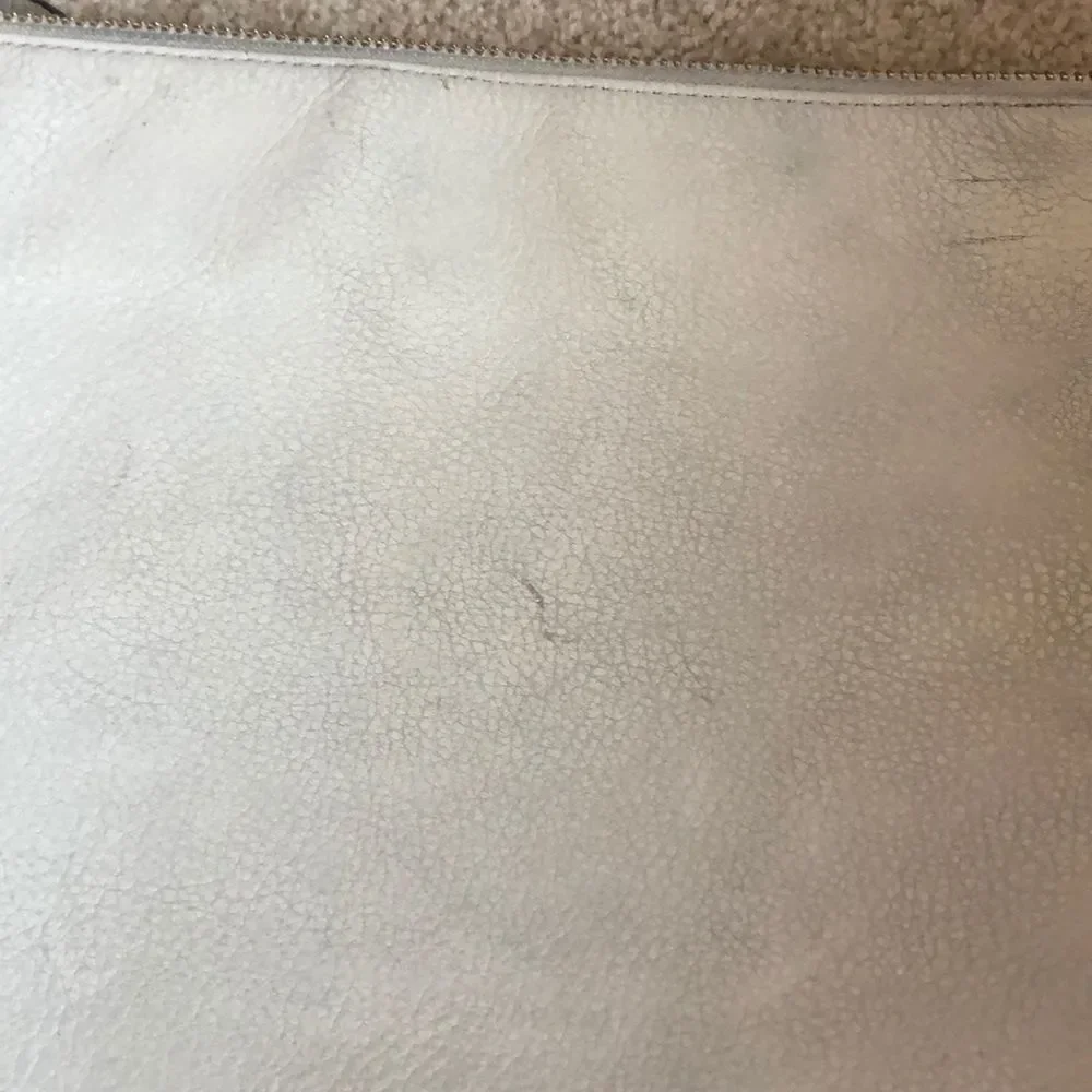 Kate Spade cream purse with a black bow